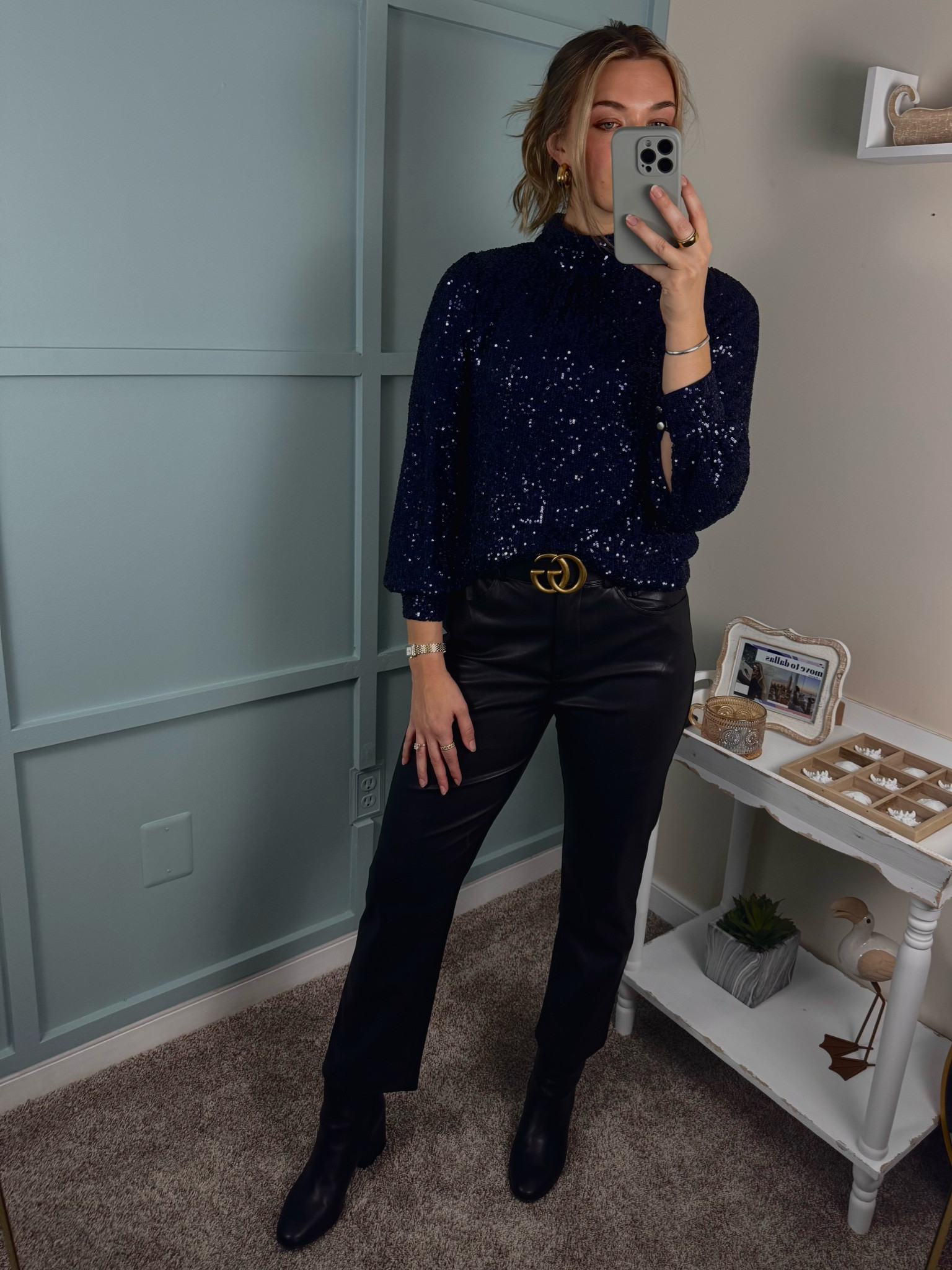 This stunning look features a sparkly navy blue high neck top that adds a touch of glam, paired with faux leather straight leg ankle pants for a sleek and edgy vibe. Black leather booties elevate the outfit, while a classic Gucci belt adds the perfect finishing touch of luxury. Perfect for a night out or special occasion! #SparklyTop #LeatherPants #GucciBelt #OOTD #NightOutLook #EdgyStyle #FashionInspo #LuxuryStyle #Booties #ChicOutfit

#LTKStyleTip #LTKShoeCrush #LTKHoliday