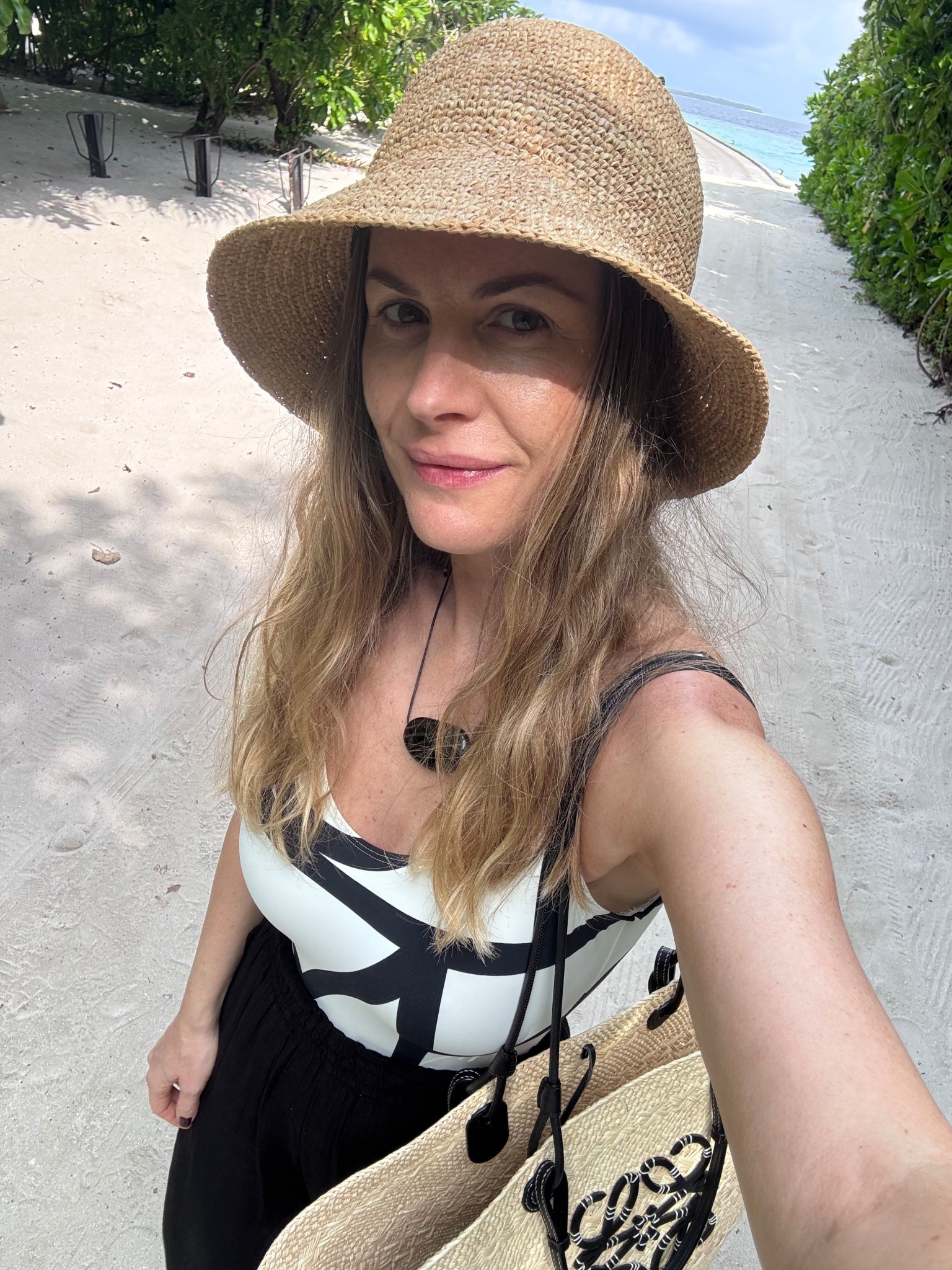 Resort wear beach vacation Toteme swimsuit raffia bucket hat black linen trousers Loewe tote bag  black cord necklace

#LTKsummer #LTKeurope #LTKuk