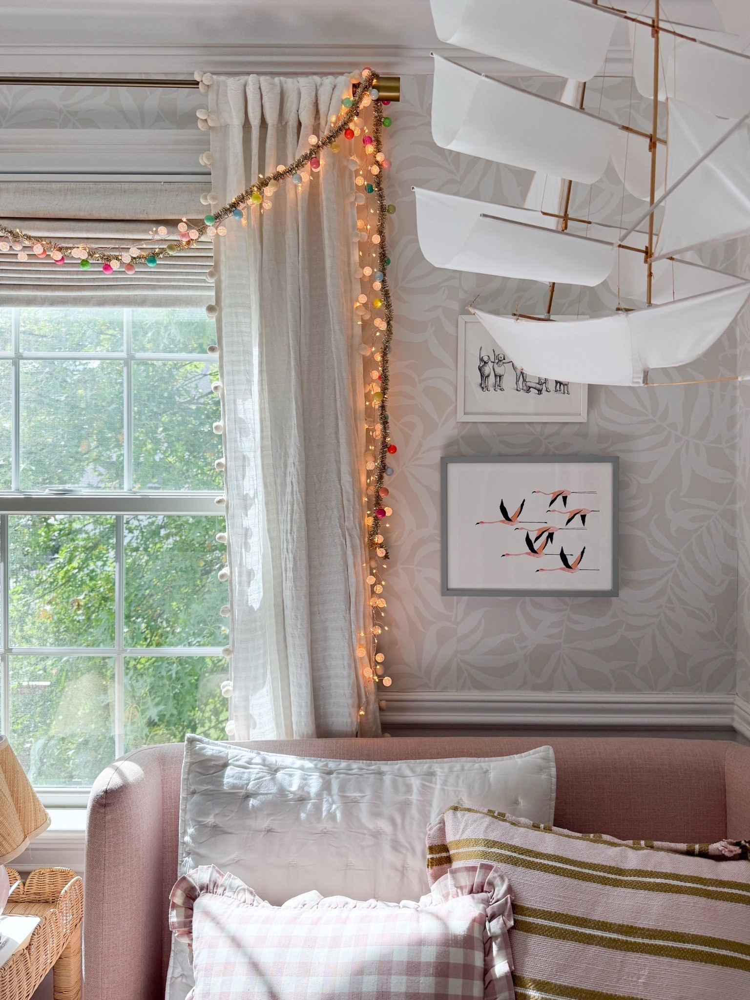 A little holiday magic in the girls’ bedroom! I love the colorful Christmas garland draped around the window, the playful sailboat light, and the mix of pink pillows. Such a fun way to make their room feel festive while keeping all the details that make it special.
girls bedroom Christmas decor, colorful Christmas garland, holiday string lights, kids room holiday decor, pink bedroom decor, sailboat chandelier, Christmas bedroom inspiration, whimsical holiday decorations, holiday pillow styling, girls room decor, girlonthehudson