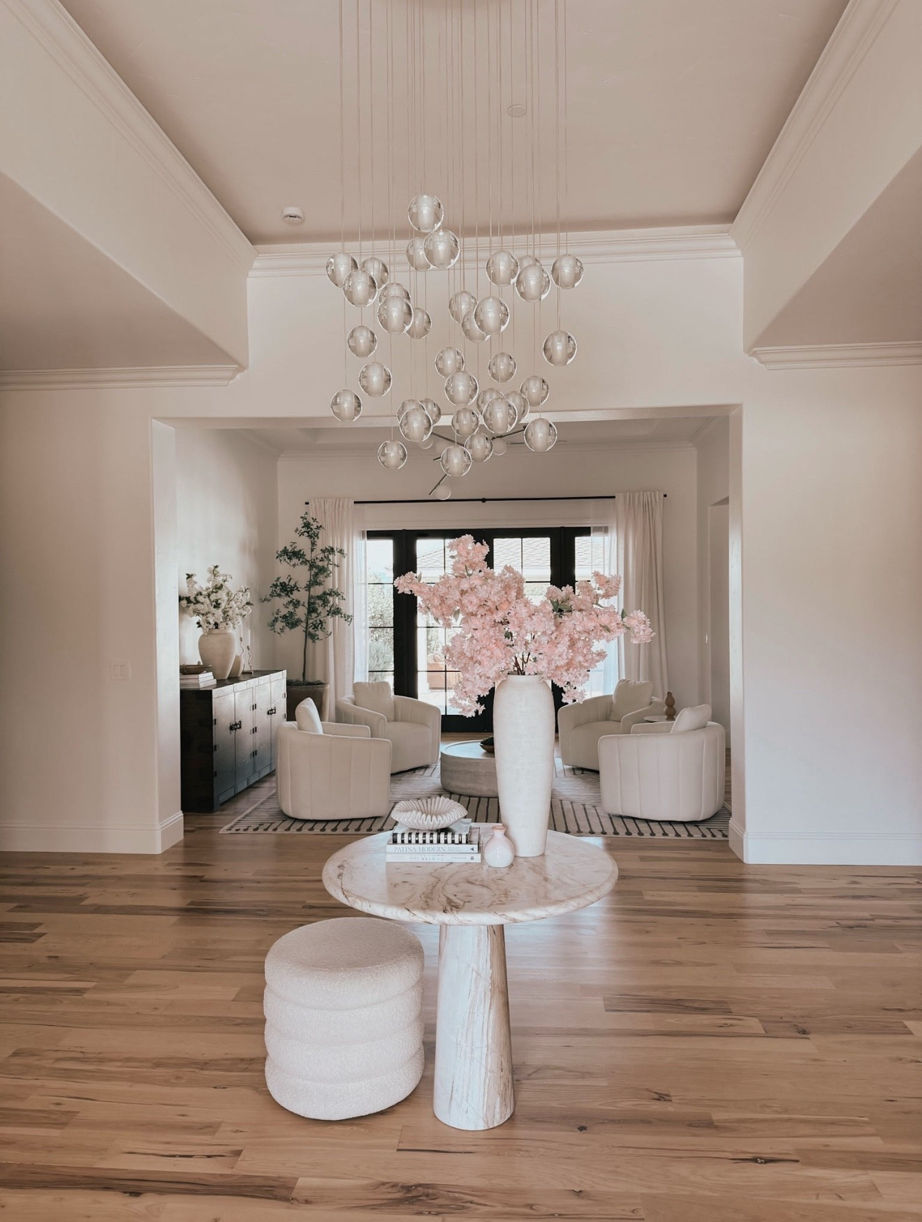 Entry way drop chandelier with a round marble table and boucle stool 

#LTKHome