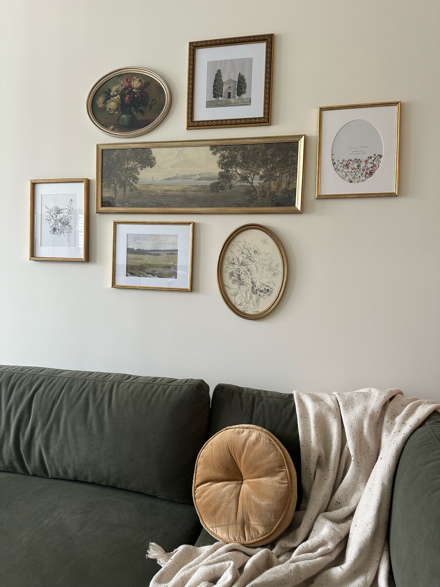 Neutral home | sitting area| vintage frames | green couch | gold frames | velvet couch | living room | office setup 