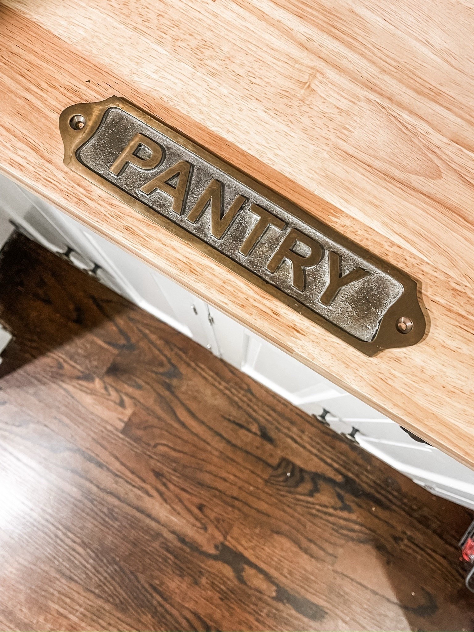 Pantry perfection ✨ A vintage-inspired brass “Pantry” sign adds charm against a natural wood countertop, crisp white cabinetry, and rich dark hardwood floors. Small details make the biggest impact in creating a timeless kitchen look. 🤍
#KitchenDetails #PantryStyle #BrassSign #WoodCountertop #WhiteCabinets #HardwoodFloors #VintageInspiredDecor #TimelessKitchen #eanesinteriors



#LTKvlog #LTKHome #LTKFindsUnder50
