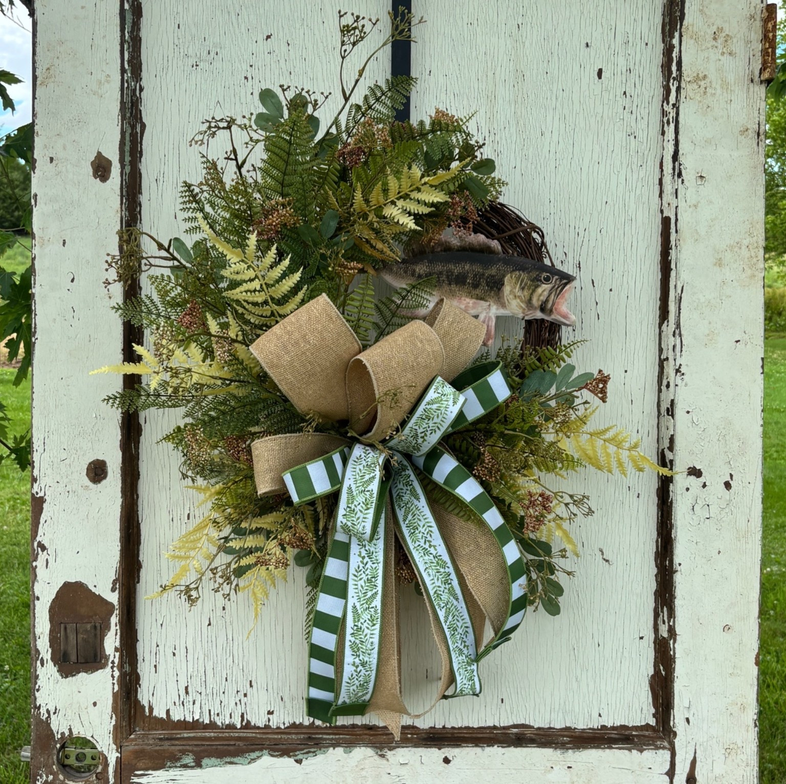 🎣 For the fisherman who has everything… except a custom front door wreath!

This handcrafted fishing wreath is the perfect addition to a lake house, cabin, man cave, or front porch. Designed with layered greenery, fern accents, a rustic bass focal, and a gorgeous burlap and green bow, it brings the beauty of the outdoors right to your front door.

#LTKHome #LTKSeasonal #LTKU