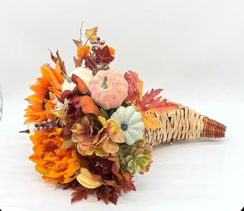 Celebrate the beauty of the season with this handcrafted fall cornucopia by DaisyMaeFloral. Bursting with rich autumn hues, this 10” arrangement features lifelike silk flowers, foliage, and gourds for a timeless harvest look. Perfect as a Thanksgiving centerpiece or festive accent, it brings cozy, seasonal charm to any table or mantel. 🍂🦃 #FallDecor #ThanksgivingCenterpiece #HarvestVibes #DaisyMaeFloral #EtsyFinds #AutumnHome #LTKHome #LTKFallDecor

#LTKSeasonal #LTKFindsUnder100 #LTKHome