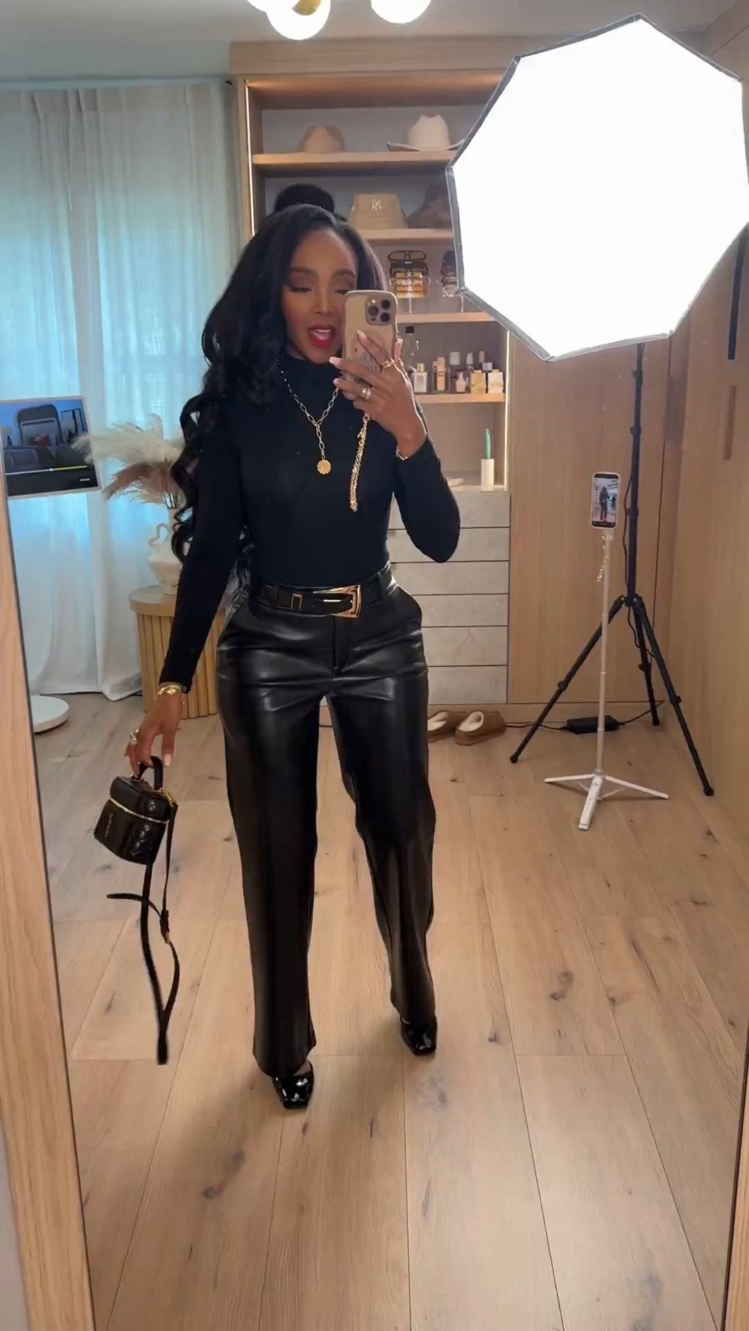 Scroll to shop 🖤  

All-black everything with a little edge. A fitted long sleeve tucked into high-waisted leather trousers for that powerful, night-out energy. Add gold accessories and a structured mini bag to elevate the entire look.  

Follow me on Instagram and YouTube @kirasfashionfinds