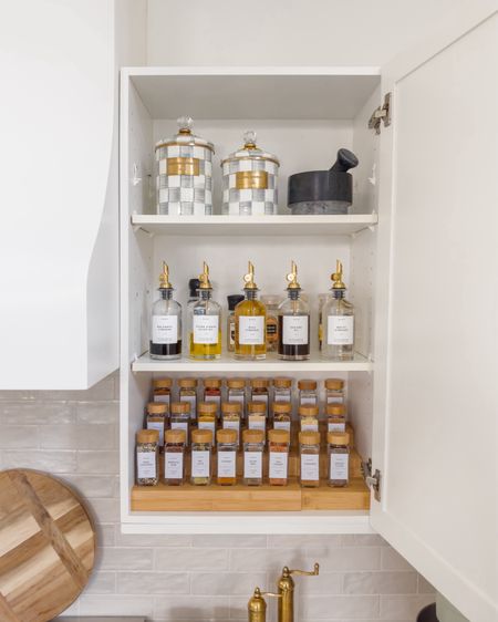 Revamp your spice cabinet the way we did it! We gave it a fresh look, and I love the results. We bought a wooden spice rack, jars topped with wooden lids, a stylish gold bottle dispenser, and charming checked canisters that are perfect for organizing things in the kitchen.
#organizationtips #kitchenessentials #affordablefinds #homemusthaves

#LTKSeasonal #LTKstyletip #LTKhome