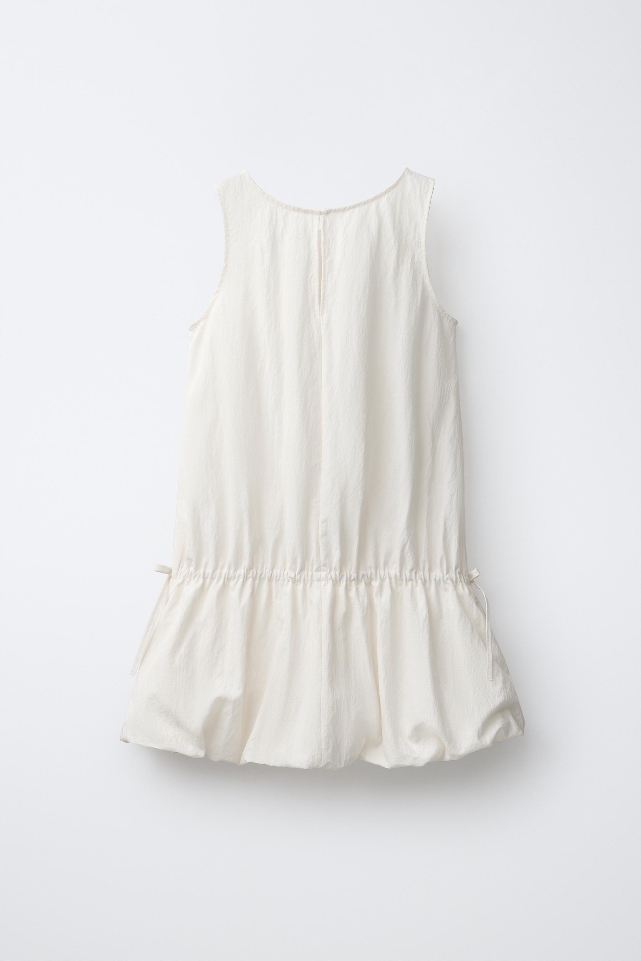 Dress with round neck and sleeveless design. Teardrop button closure at the back. Elastic detail ... | Zara US
