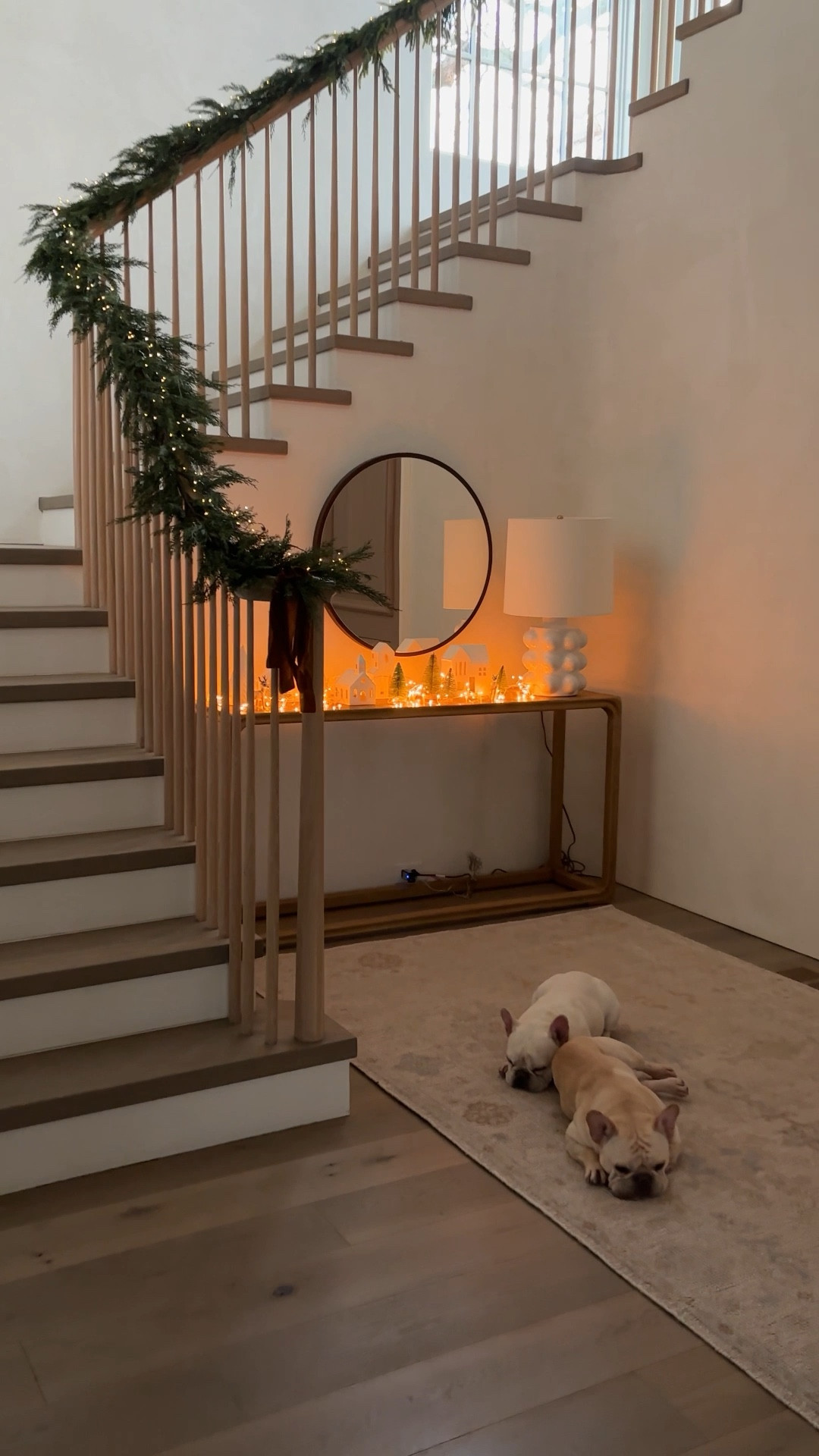 It took some trial and error to find the right garland and lights for our entryway.  I finally realistic garland with no oder and the most delicate lights for the garland and our Christmas houses.

#LTKSeasonal #LTKHoliday #LTKWatchNow