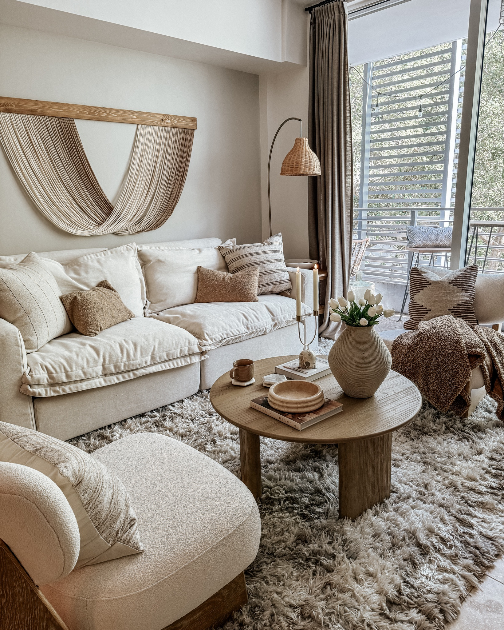 coffee table styling 

wood round coffee table, coffee table decor, vase, candle holder, boho art, white sofa, boucle accent chair, floor lamp, throw pillows, neutral living room, living room decor, living room furniture, organic modern living room 

#LTKhome