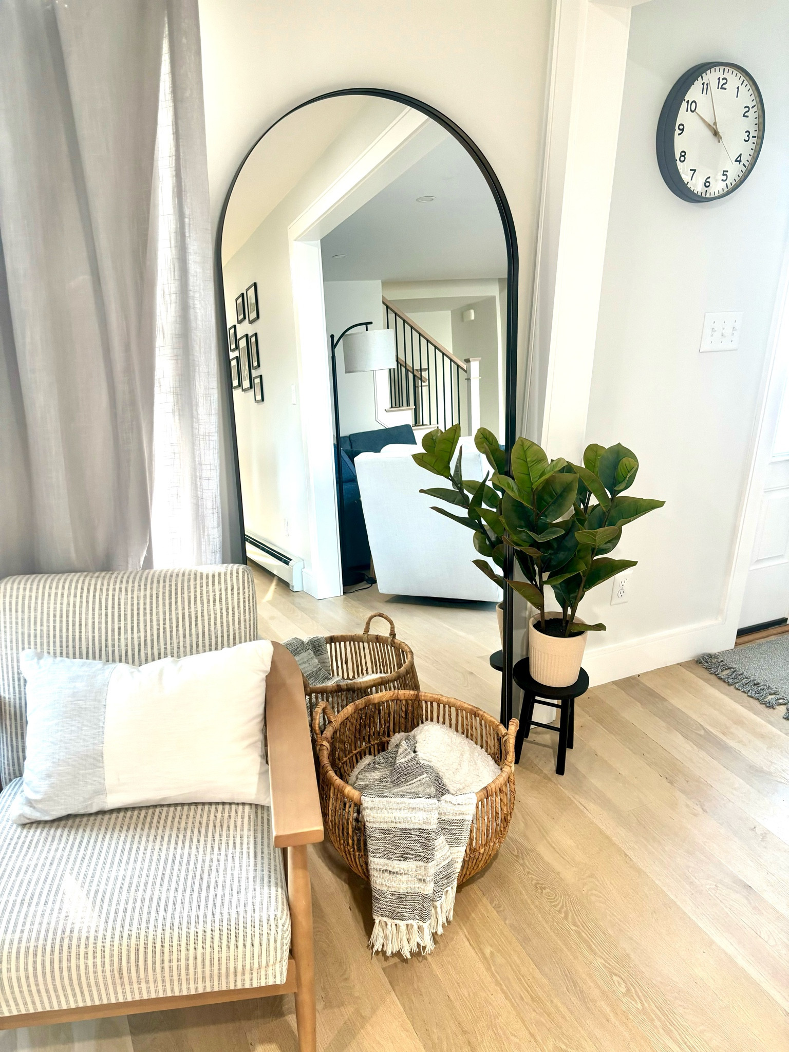 Black metal arched large stand up mirror to decorate your interior design home. Dining room, living room. Plant stand with faux plant and basket with blankets. 

#LTKfamily #LTKhome #LTKCyberWeek