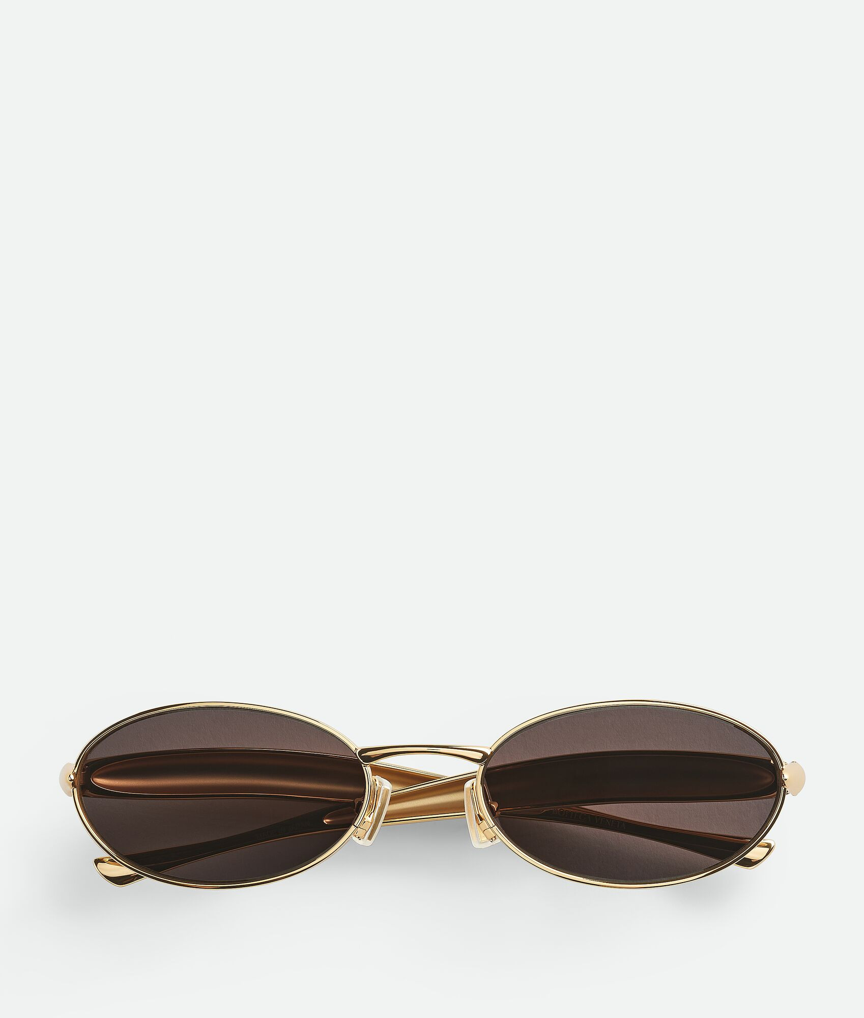 Bottega Veneta® Sardine Oval Sunglasses in Gold/grey. Shop online now. | Bottega Veneta