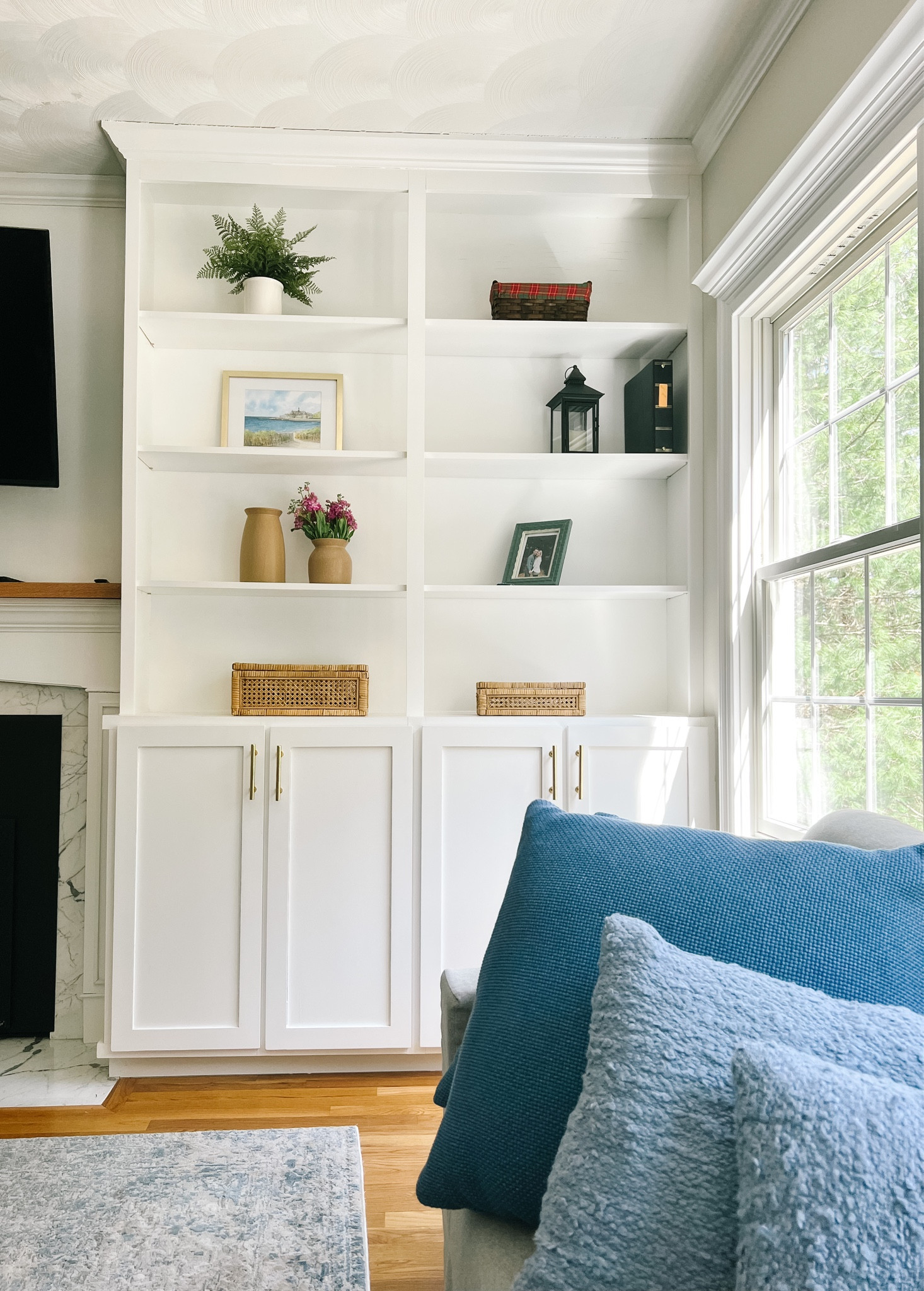 Spring decor refresh for built in shelves. My favorite cane and rattan boxes from Amazon, pretty blue throw pillows, and ceramic vases with fresh florals from target!

#LTKSeasonal #LTKhome