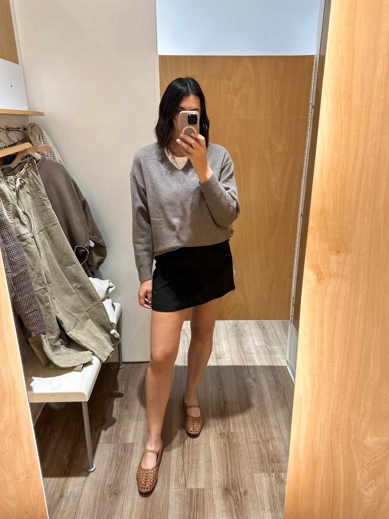 I’m in the medium of the sweater, fits loose and oversized.

I’m in the large of the skirt for length.