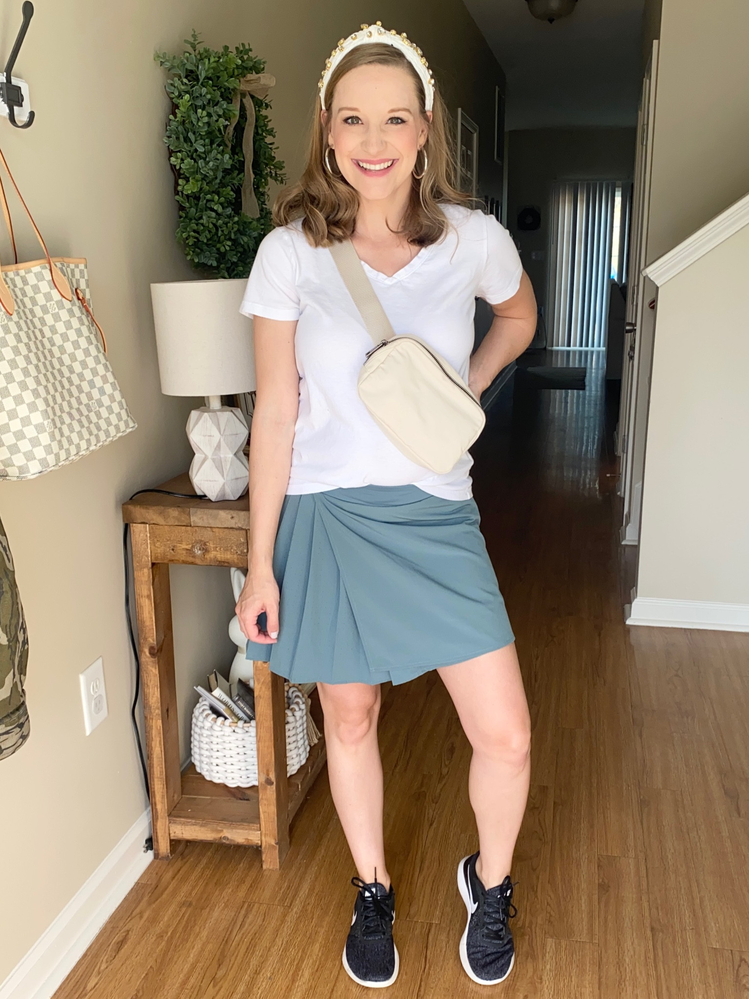 Walmart athletic skirt paired with a white tshirt, black Nike tennis shoes and a belt bag! Stay at home mom outfit! Athletic skort! White v-neck tshirt! 