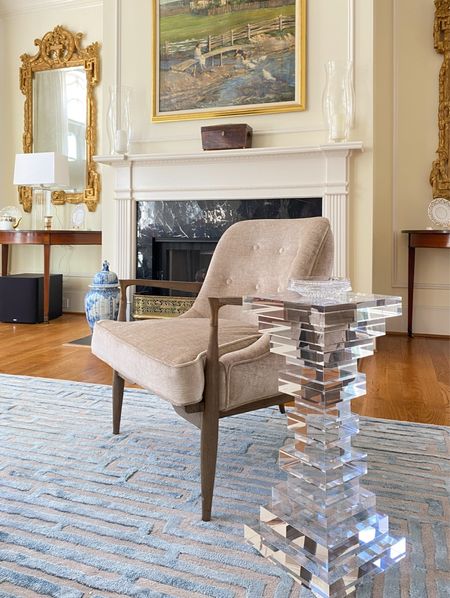 Chic acrylic side table, designer mid-century lounge chair, and luxe crystal table lamp in a traditional living room design 

#LTKhome #LTKstyletip