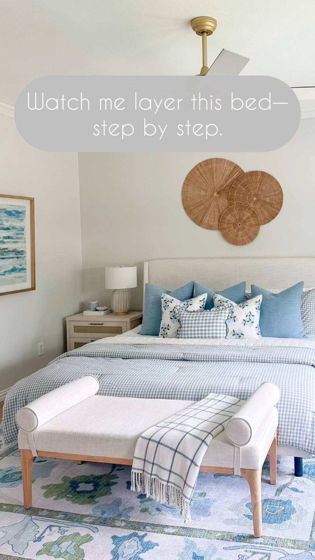 Coastal bedroom styling made simple
Layering textures, patterns, and timeless furniture pieces to create a calm, pulled-together space that feels both lived-in and elevated. Every detail is budget-friendly but looks designer.
	•	Blue and green Oushak-style rug (sets the tone with soft pattern + color)
	•	White upholstered bench with wood legs (adds structure at the foot of the bed)
	•	Windowpane throw blanket (adds a casual, cozy layer)
	•	Blue gingham comforter (folded for volume and interest)
	•	White quilt (foundation layer for a crisp, clean look)
	•	Light blue euro pillows (for height and softness)
	•	Floral pillow covers (Amazon – great for mixing prints)
	•	Gingham lumbar pillow (ties the look together)
	•	Ribbed ceramic table lamps (neutral and textural)
	•	White nightstands with wood detailing (warm and clean-lined)
	•	Woven wall plaques over the bed (adds texture + natural contrast)
	•	Gold arched floor mirror (opens up the space and adds shine)
	•	Electric fireplace (modern and space-saving for extra coziness)
	•	Framed art TV (blends tech with style—love this for bedrooms)
	•	Coastal armchairs in the seating area (light, classic, and perfect for reading or relaxing)
	•	Soft blue curtains (complete the room and pull the tones from the rug)

Every item was styled with comfort and layering in mind—coastal, classic, and completely approachable.

#LTKHome #LTKFinds #bedroomstyling #coastalstyle #serenaandlilylook #budgetdecor #homerefresh #shannongolddesign



#LTKHome #LTKStyleTip #LTKFindsUnder50