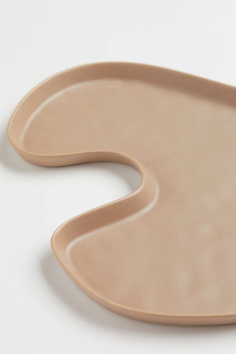 Tray in glazed stoneware. Irregular shape with a low rim. Height 1/2 in. Length 10 1/4 in. Width ... | H&M (US)