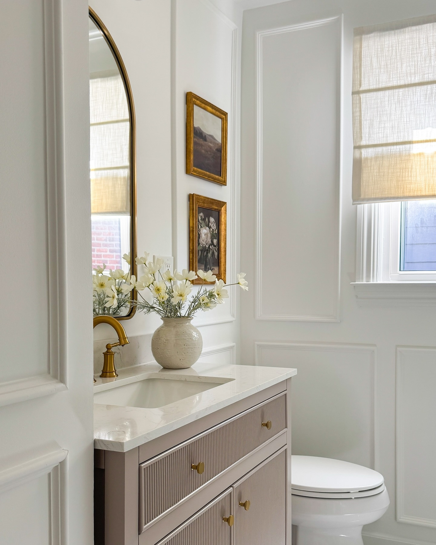 
Our bathroom was a complete renovation and it was soooo worth it. We touched every inch of this space and now it finally feels like “us.”

Here’s what we changed…
• Removed the old tub and created a walk-in shower with floor to ceiling glazed Spanish tile
• Swapped the bulky vanity for a warm fluted one with brass details
• Upgraded to a sleek fluted vanity
• Added an arched mirror to soften the space (my favorite detail) ✨
• Installed new lighting and brass fixtures throughout
• Brought in classic wall moulding for an elevated, custom look
• Layered in warm textures, soft neutrals, and simple art to finish it off

I’ll be sharing a full cost breakdown soon… because I know how helpful that is when planning a reno.



#BathroomReno #BeforeAndAfter #NeutralBathroom #WalkInShowerGoals #OrganicModernStyle #RealLifeRenovation

#LTKWatchNow #LTKHome #LTKStyleTip