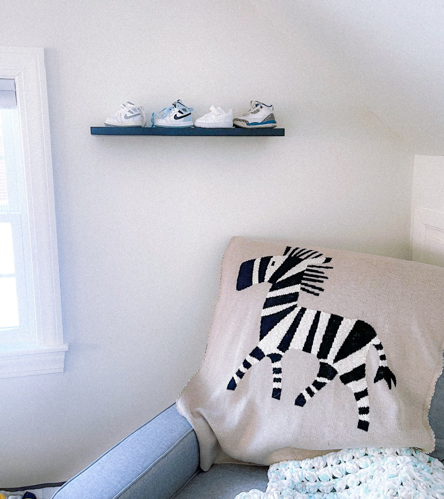 Baby shoe sneaker display 
Floating shelf 24 inches 
Baby room boys bedroom 
Sneaker organizer 
Zebra blanket 

#LTKBaby #LTKHome #LTKKids