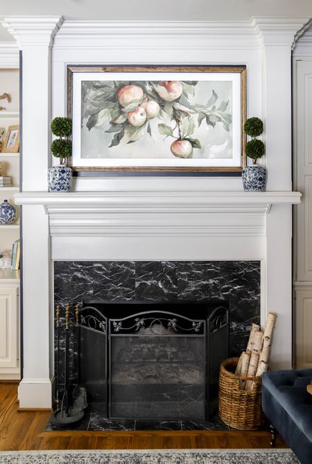 My picture frame TV often features this apple tree watercolor. It looks great with my ginger jars and topiaries on the mantle.

#LTKhome