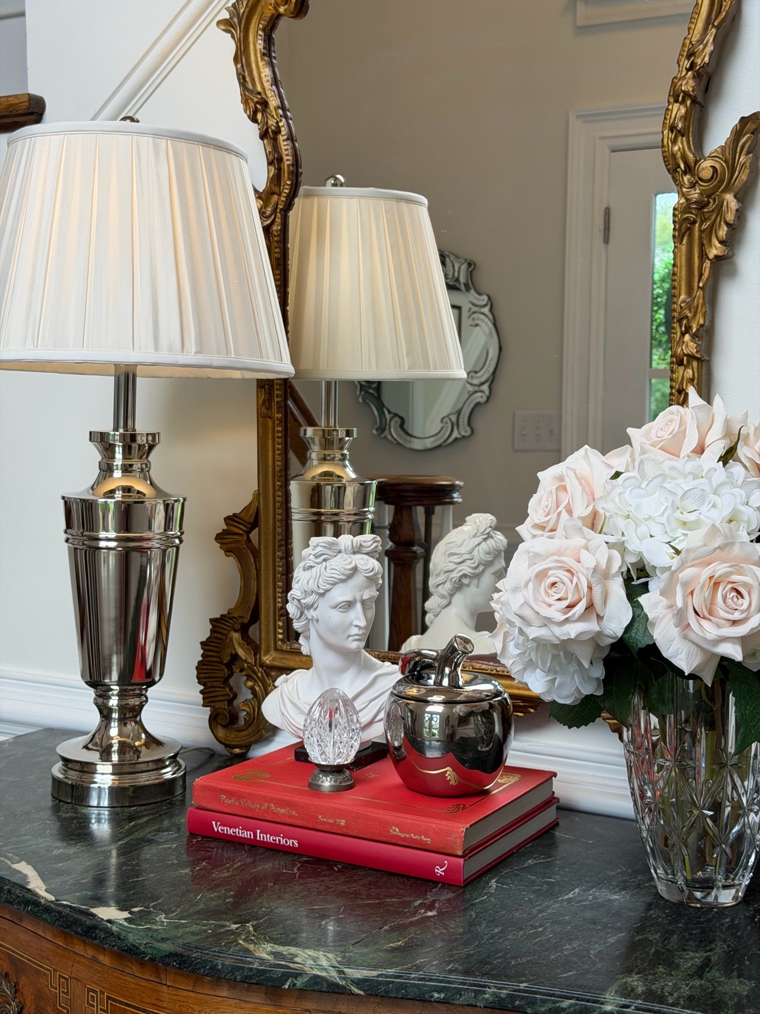 Timeless foyer styling with polished nickel, pleated lampshades, fresh florals, classic coffee table books, and elegant traditional décor. I’ve linked my lamp, pleated shade, accessories, and decor pieces to help you recreate this collected Ralph Lauren-inspired look.

#LTKHome