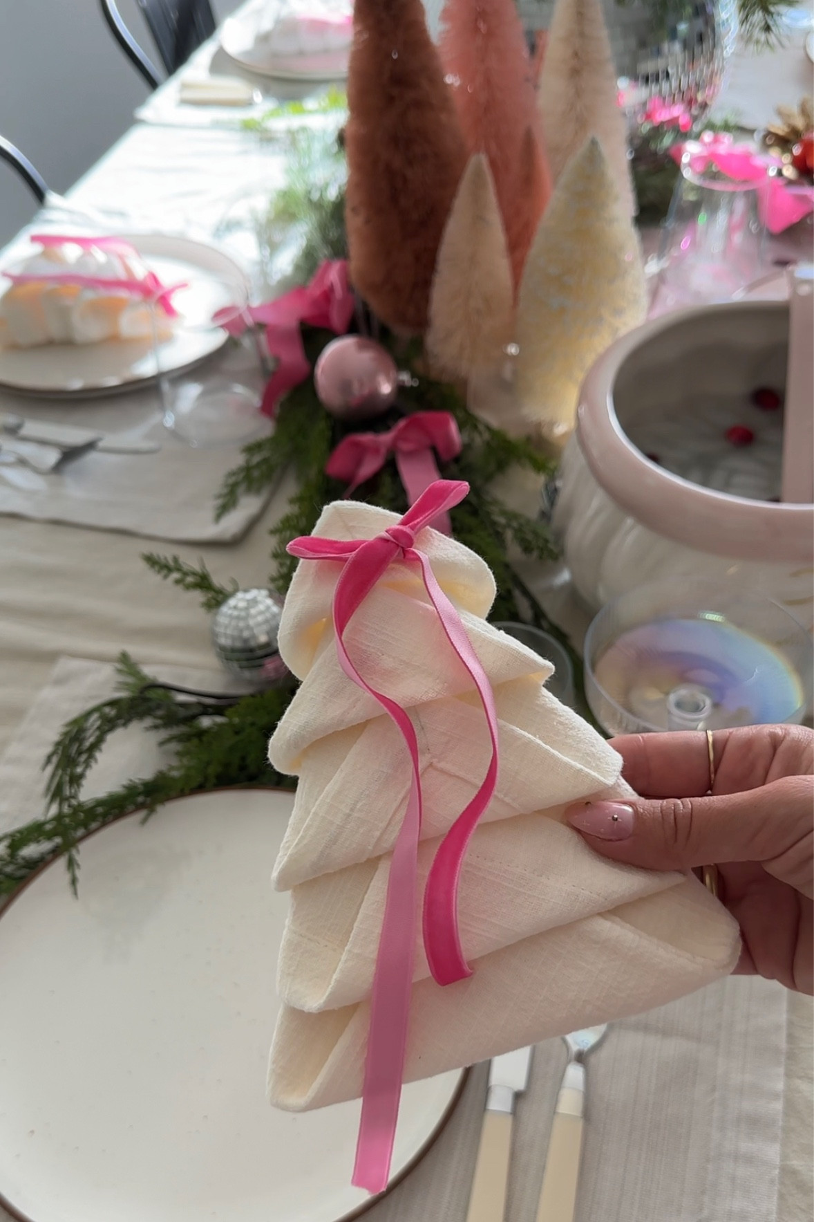 an easy and extra cute way to fold a napkin into a tree shape for your christmas tablescape! just add a pop of color with a velvet ribbon bow!

+fold napkin into a half
+fold napkin into a square 
+bring the corners in (stacking)
+flip over 
+bring each corner onto the middle 
+fold the triangles upward tucking in after the first!


#LTKHoliday #LTKHome #LTKSeasonal