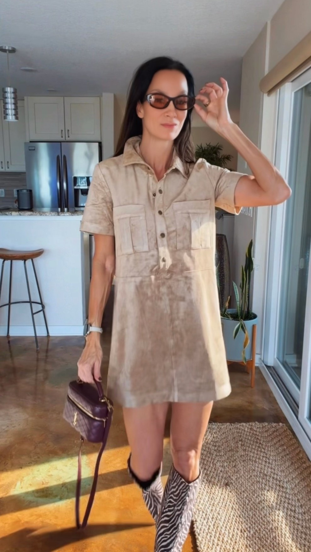 The boots are doing the talking. 🦓🤎 Styled this neutral short-sleeve shirt dress with zebra-print knee-high boots, a burgundy Saint Laurent bag, and brown sunglasses. An easy fall outfit formula: a simple dress + statement boots + a rich-colored bag. Shop the pieces below!