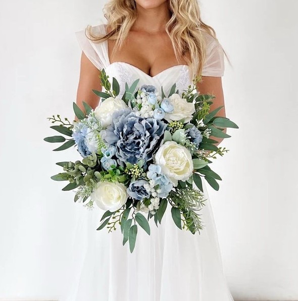 This dreamy dusty blue bridal bouquet brings soft elegance and timeless romance to your wedding day. Featuring lifelike silk blooms in shades of blue, dusty blue, light blue, champagne, and white with touches of eucalyptus greenery, it creates a serene and sophisticated palette perfect for classic, coastal, or garden-inspired weddings. The champagne satin ribbon-wrapped handle adds a polished bridal finish, while the everlasting flowers ensure your bouquet stays beautiful long after the celebration. #LTKwedding #bridalbouquet #dustybluewedding #bluewedding #weddinginspiration #bridestyle #silkflowers #weddingdecor #bridetobe #weddingflowers

#LTKWedding #LTKSeasonal #LTKHome