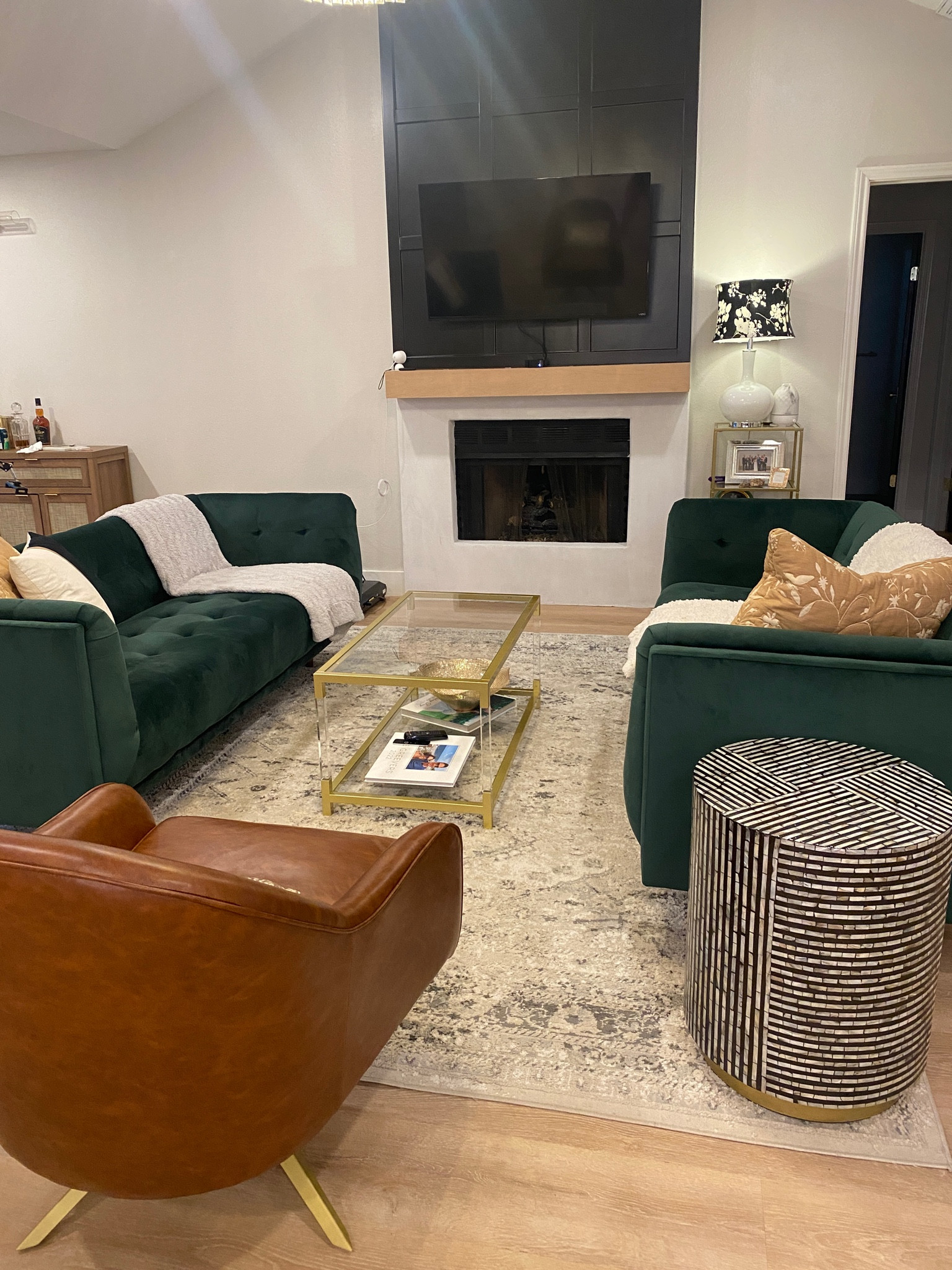 Living room is coming together with a new coffee table!
Glass coffee table, accent chair, leather chair, green sofa, modern living roomm

#LTKHome