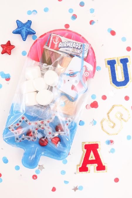 DIY hostess, teacher, or friend PATRIOTIC gift idea! Grab this cute rocket pop tray from @dollartree and put these fun gifts inside!
 A mini smores kit (individual servings) with some fun light up glasses, star straw, BOW Stanley cup straw cover and a gift card.
Seal it up with some cellophane & hot glue!
Save this quick & easy summer holiday gift idea!
 
#diyteachergifts #diygiftcardholder #diyfriendgift #diyhostessgift
 

#LTKParties #LTKSeasonal #LTKGiftGuide