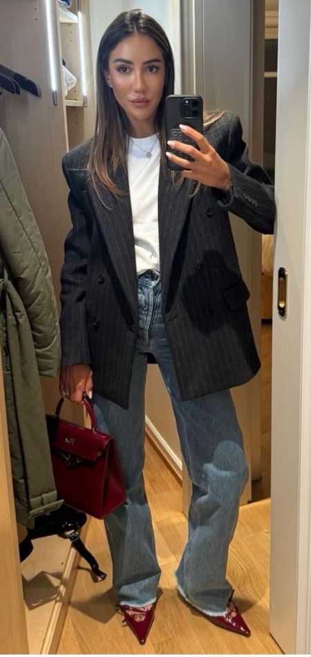 Navy and white striped blazer, straight leg jeans, red pointed heels and red purse. 2024 outfit inspo | Work outfit inspo 
