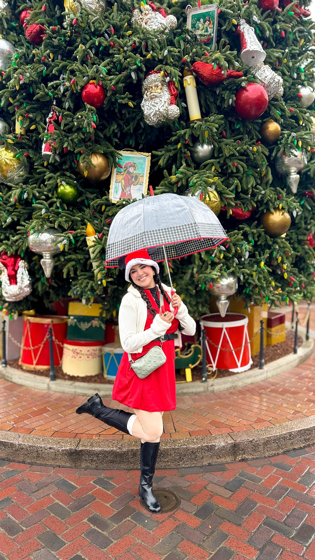 ☔️Celebrating the holiday season at the Disneyland Resort in the rain but in Disney Christmas style🎄♥️☺️🐭

💁🏻‍♀️Felt festive and put together a Mrs.Clause inspired outfit! This dress is a gorgeous red that can be repurposed for Christmas, the new year, Valentine’s Day or date night. Add this to your closet ASAP 😍

I styled the dress to be more conservative because this dress does have a deep V neckline in case that’s more your vibe. I paired it with a mesh long sleeve top and black shirt. ✨

🥰 I was warm the entire time thanks to my thermal leggings. They are very comfortable and breathable thanks to the fabric! I wore longer socks over them with black boots which kept my feet dry from the rain. 

For the accessories I wore a black belt, gold jewelry and took this bag because it fits so much with the amount of compartments it has. The color for this bag is also beautiful 😄 

Rain or shine you can look your best 💯 Need more holiday outfit inspo or need help with getting gifts this year? Lmk in the comments what you’re searching for and if be happy to share some recommendations 🫶🏼

Disney Christmas outfits, Santa inspired outfit, Disney Style, holiday red dress, winter thermals for the cold, colorful rainy day outfit, Angie’s Magical Style, Mickey Mouse holiday ears 

#LTKHoliday #LTKootd #LTKGiftGuide