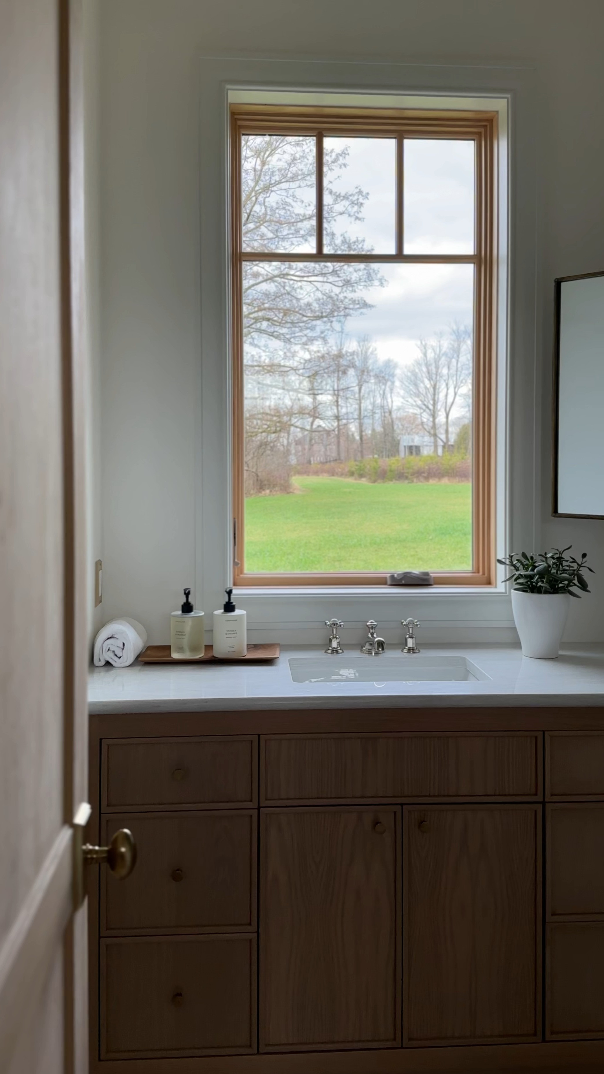 Adding some sweet design touches to our Casa Lane ensuite! Just hung the mirror – next on the list: a soft Roman shade, a cozy bath mat, and towels fluffier than a freshly blow-dried poodle. Can't wait to see this space come together but can't decide between the scalloped edge or the Amber Lewis ivory rug for the bath mat. HALP.  

 