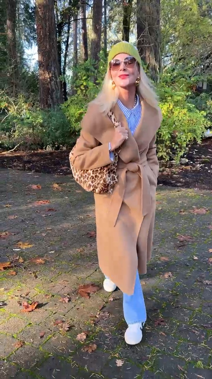 Nothing more classic than this gorgeous camel coat! Cozy and warm for the cooler fall temps, I am loving it paired with my favorite denim and easy blue striped button down! Accessories make the outfit with a fun bag, bright hat and big earrings!

Coats, classic style, style over 50, fall vibes, denim, sneakers  

#LTKSeasonal #LTKStyleTip #LTKOver40