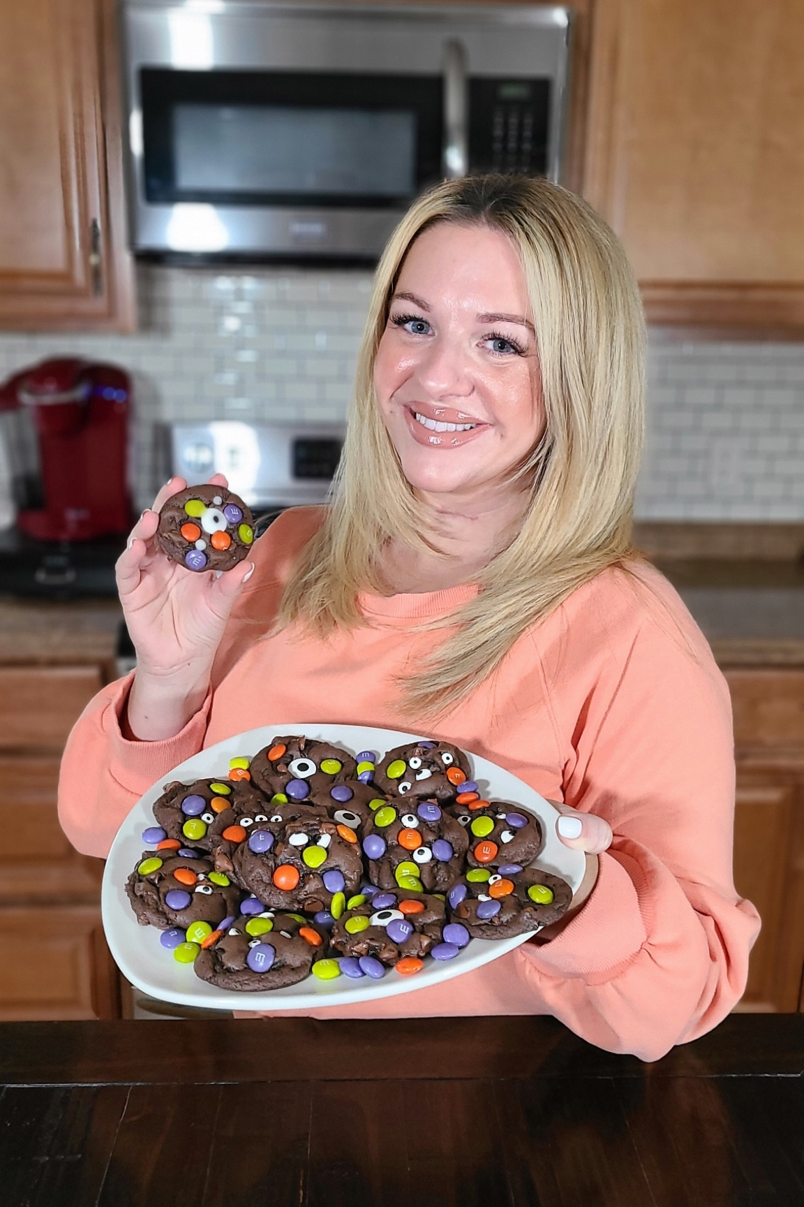 A simple cake mix chocolate cookie embellished with Halloween M&Ms and candy eyes. Your kids are sure to love my monster cookie recipe.

Recipe:
• 2 Eggs, large
• 1 15oz box Chocolate cake mix
• 3/4 cup Chocolate chips
• 1/3 cup Butter, melte
• 1 bag M&M's Ghouls Mix
• candy Eyes

Instructions: 
Mix eggs and melted butter.
Mix in cake mix, it will be very thick, keep mixing! 
Fold in Chocolate chips.
Scoop 1Tbs dough balls on parchment lined baking sheet. 
Press in a few M&M's.
Bake at 350°f for 8-10 min until tops are set.
Remove from oven and place on candy eyes. Caution cookies will be hot! 