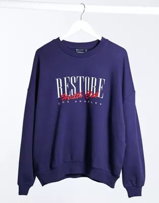 ASOS DESIGN sweatshirt with retro sporty restore print in navy | ASOS (Global)
