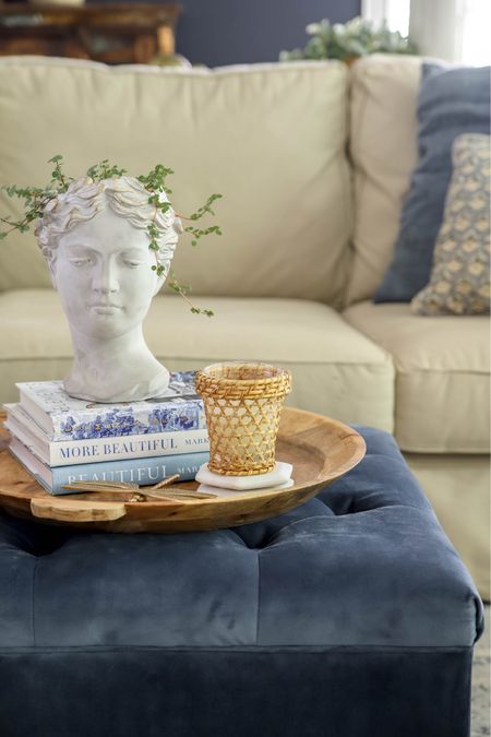 My ottoman decor has an oversized wooden tray,  a Grecian bust planter, a brass dragonfly, coasters, a candle and my favorite coffee table books.

#LTKhome