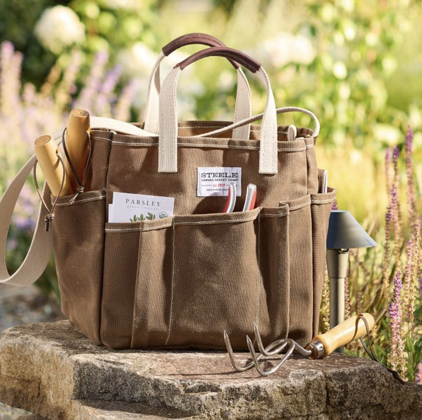 This canvas utility tote has such a sturdy construction, and the leather handles make it easy to transport — perfect for all your gardening needs! #gardentools #gardensupplies #gardening #homegarden #garden #gardeningtools #gardeningsupplies #gardenbag #utilitybag 

 #LTKSeasonal #LTKOver40 #LTKHome
