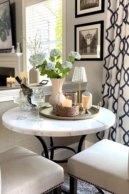 Memorial Day sales and breakfast nook styling! Shop my marble bistro table on sale, area rug, coastal candle, touch light, curtain panels, florals, trays. Prosecco coupe glasses, ice bucket. Summer home decor styling 

#LTKSaleAlert #LTKFindsUnder50 #LTKHome