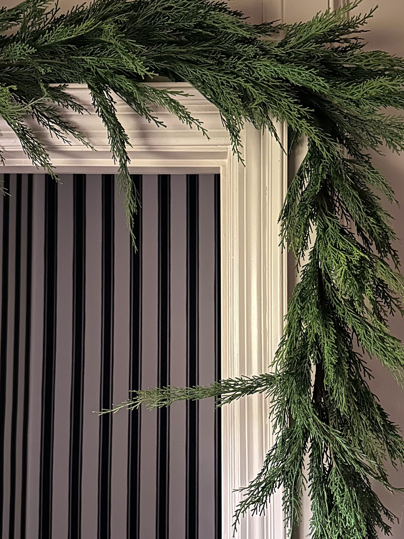 This year I decorated the bathroom with some simple garland around done door frame using these cup hooks. I drilled them into the top of the door frame and they screw in, so I’ll unscrew them and rescrew each year and you won’t see the holes! The garland just tucks on top and I added some stems to the end to keep things looking seamless. 

#LTKHome #LTKSeasonal #LTKHoliday