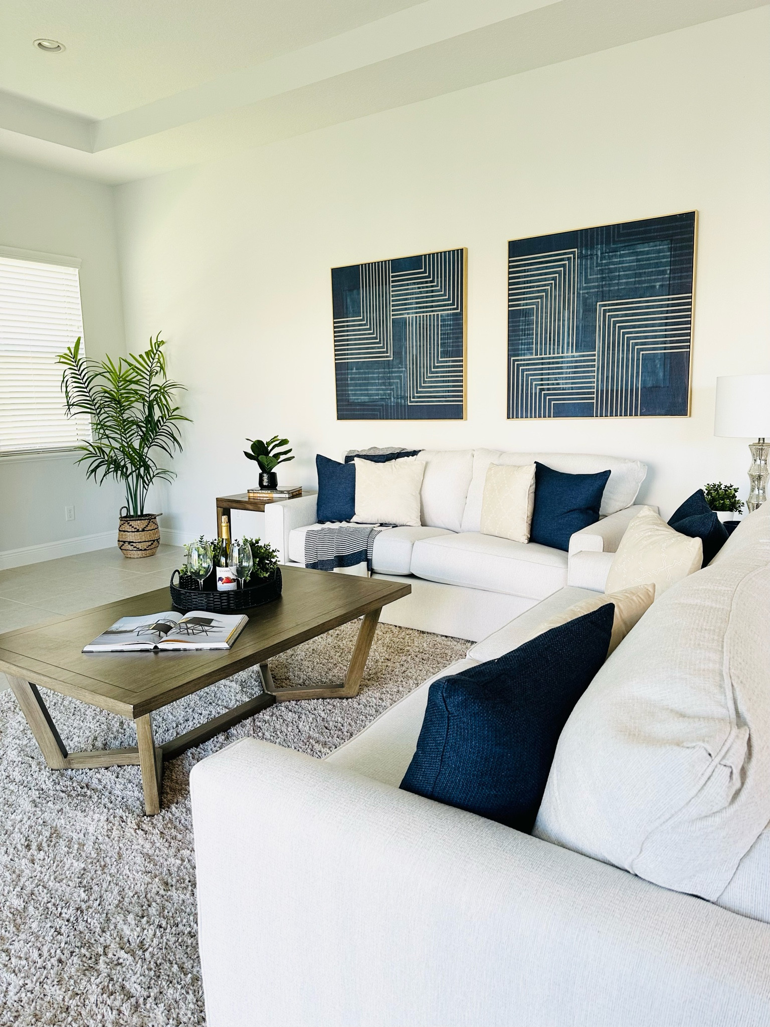 Blue and White Contemporary Living Room Design with wood coffee and end table, faux plants, blue and white pillows and throw blanket. 

#LTKstyletip #LTKhome