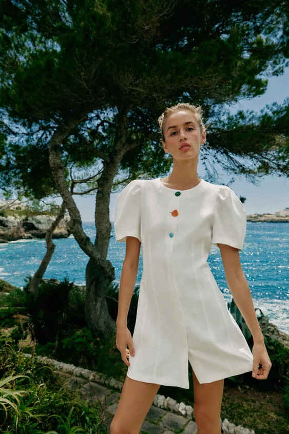 Round neck dress with short balloon sleeves and shoulder pleats. Front button closure. | Zara US