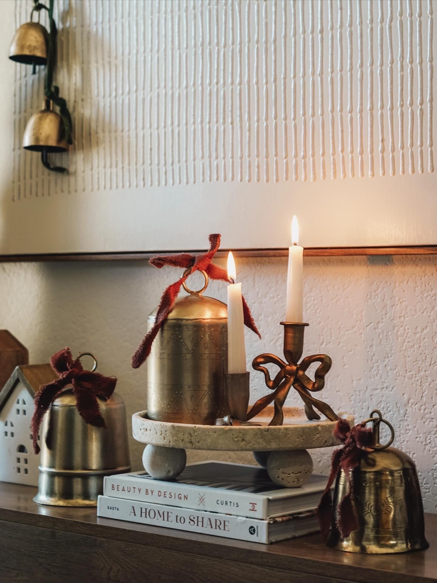 Entryway console table, brass bell decor, bow candle holder, velvet bows, wood house figurines 

#LTKHoliday #LTKHome