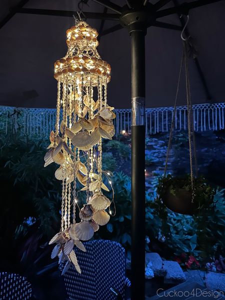 Make your own outdoor solar seashell chandelier with this seashell wind chime and wrap it with outdoor solar fairy lights. I hung mine inside my fringes patio umbrella 

#LTKSeasonal #LTKhome #LTKstyletip