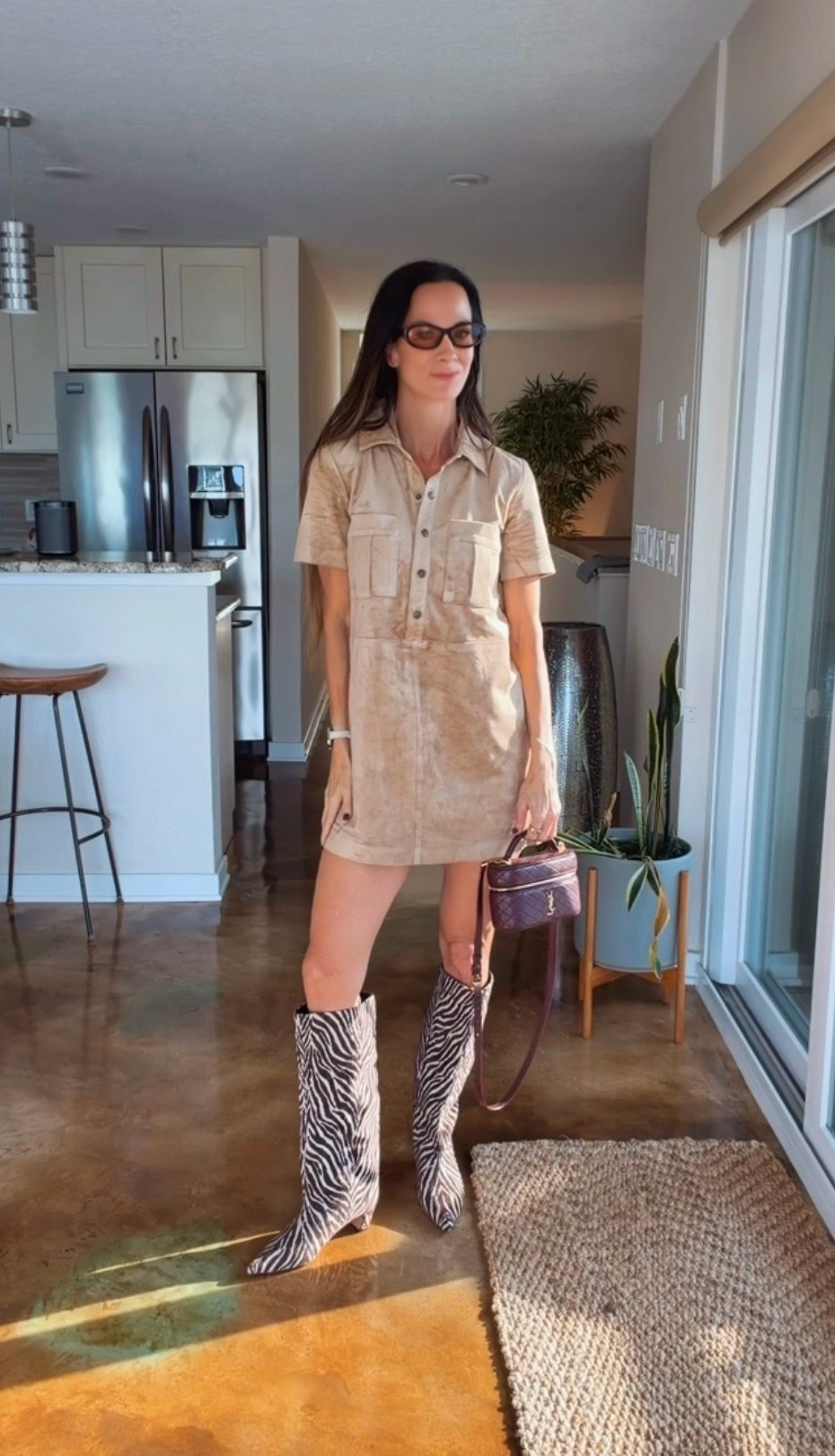 The boots are doing the talking. 🦓🤎 Styled this neutral short-sleeve shirt dress with zebra-print knee-high boots, a burgundy Saint Laurent bag, and brown sunglasses. An easy fall outfit formula: a simple dress + statement boots + a rich-colored bag. Shop the pieces below!