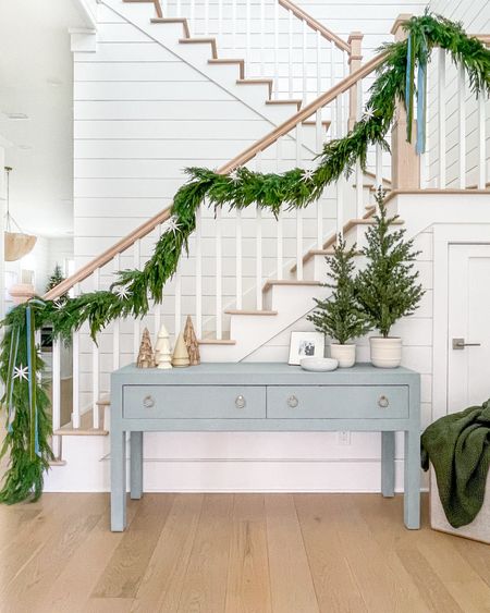 A peek at our Christmas entryway! Includes our blue console table, two types of garland, velvet ribbon, potted trees, sparkly white star ornaments, cozy bobble knit throw blanket and mixed Christmas trees. And a lot of it is currently on sale!
.
#ltkhome #ltkholiday #ltksalealert #ltkfindsunder50 #ltkfindsunder100 #ltkstyletip #ltkseasonal #ltkcyberweek #ltkover40 Christmas staircase, Christmas decorating ideas, coastal Christmas decor

#LTKsalealert #LTKHoliday #LTKhome