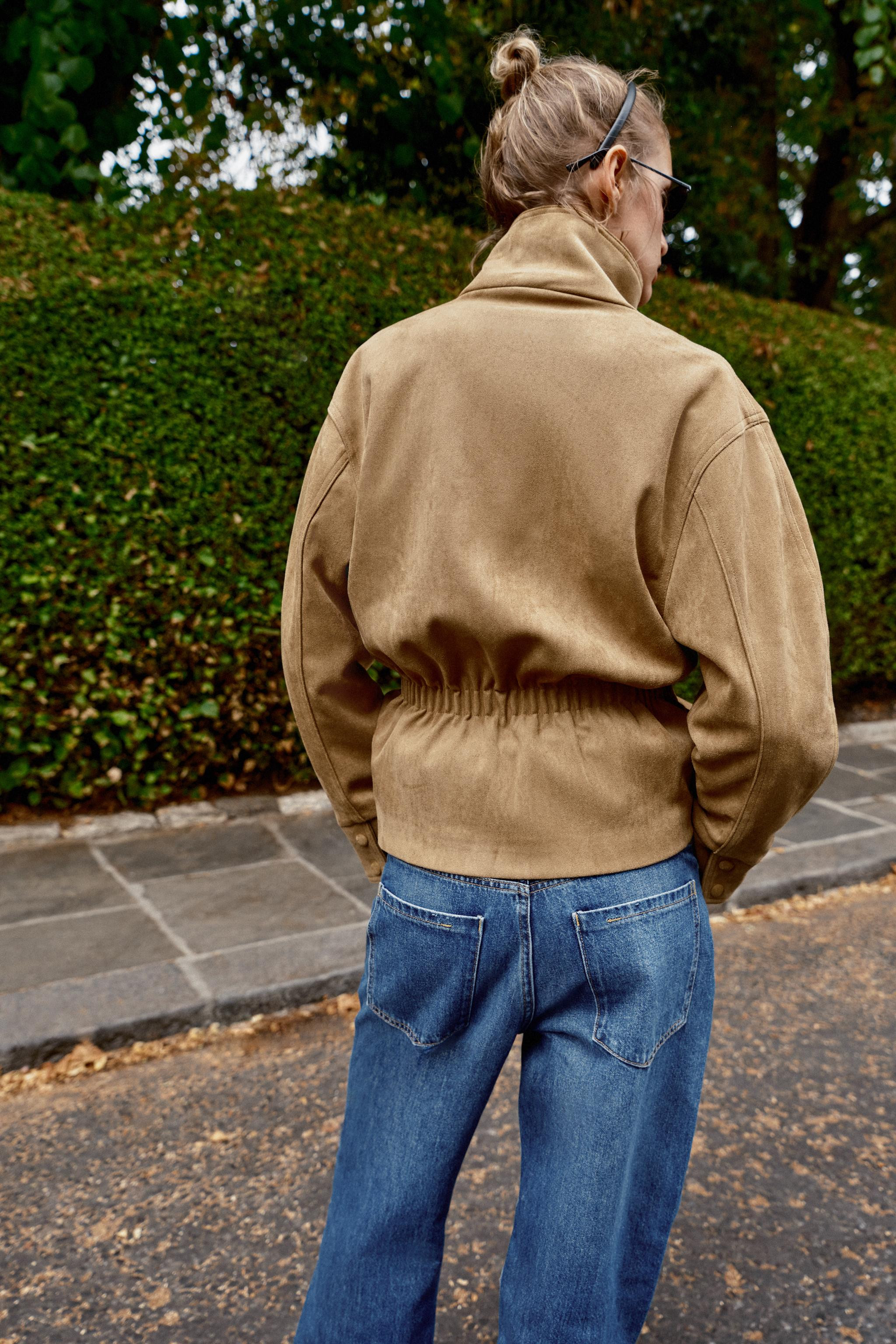 High-neck jacket with long sleeves. Front pockets. Features a matching fabric belt and gathered d... | Zara UK