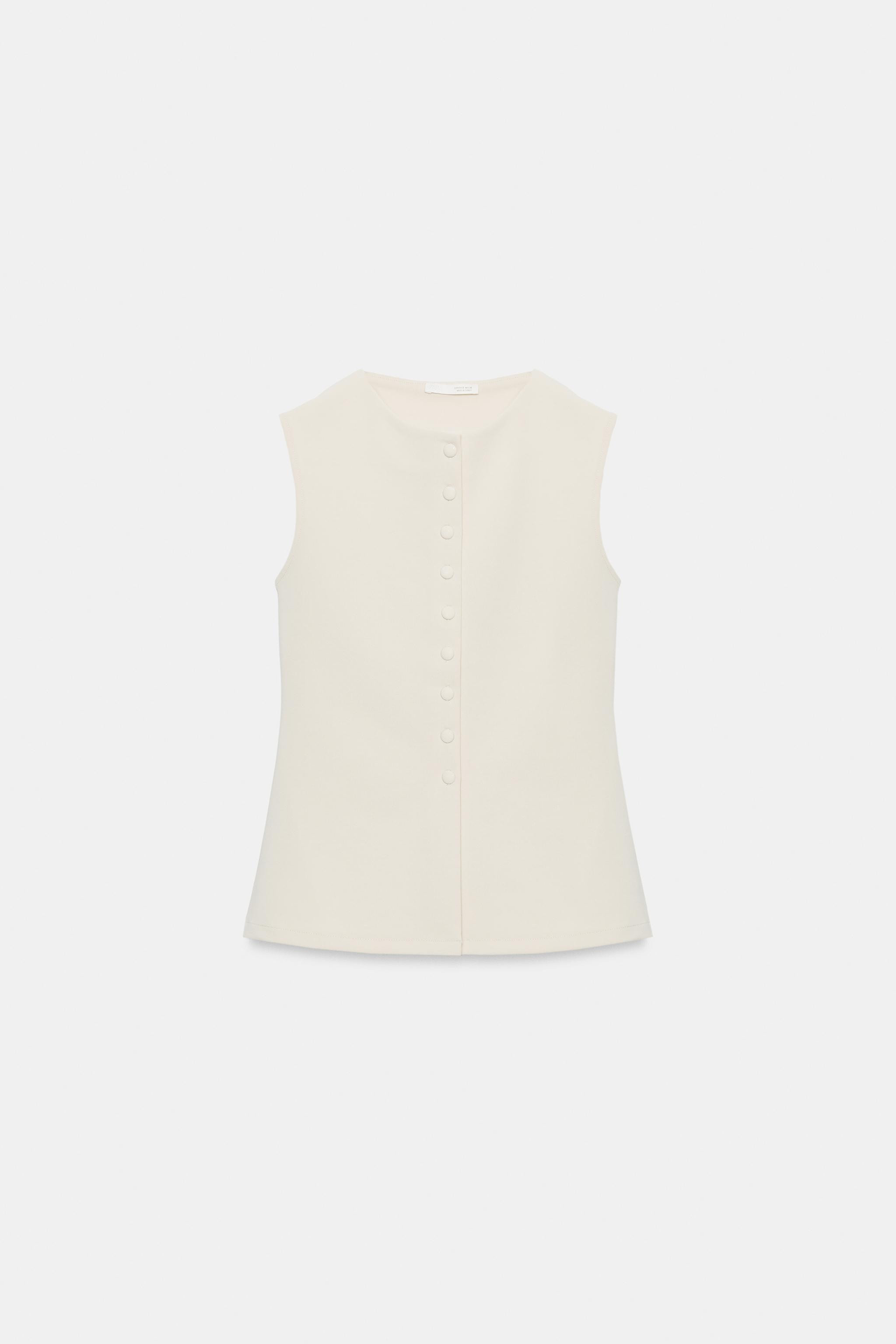 Round neck waistcoat with sleeveless design. Straight hem. Front fastening with matching fabric-c... | Zara UK