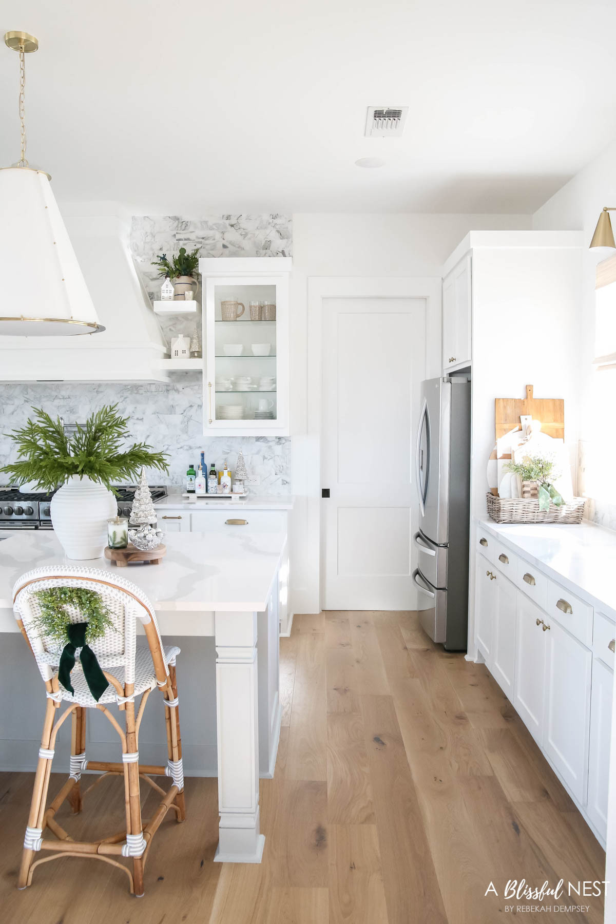 Simple touches of greenery make the kitchen feel so cheerful for the season. Tap to shop the look.
Illuminated mercury Christmas trees, artificial Norfolk pine branches, suede velvet ribbon, faux juniper wreath, textured ribbed vase, Thymes Frasier Fir candle, Mud Pie utensil holder, white wood board, round wood board, Christmas village houses 

 #LTKHoliday #LTKSeasonal #LTKHome