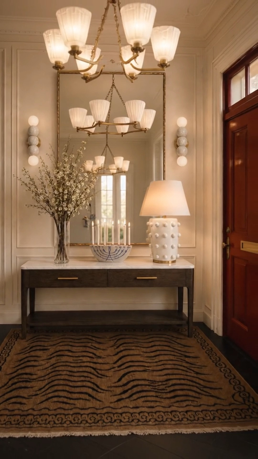 Coming home to timeless design. ✨

I love how this entry balances modern classic style with a warm, collected feeling—the rich wood console, marble top, oversized mirror, sculptural lighting, and zebra-inspired rug all feel elegant without being overly formal.

As evening settles in, the chandelier, table lamp, and candlelight create such a welcoming glow. It’s the kind of space that feels polished when guests arrive, yet even better when you’re simply coming back home.

With the Labor Day Sale happening now, it’s a perfect time to bring in timeless pieces that can elevate your entry well beyond the season.

#ModernClassic #TimelessDesign #Entryway #EntrywayDesign #EntrywayDecor #ConsoleTable #MarbleConsole #StatementMirror #Chandelier #TableLamp #Candlelight #ZebraRug #ClassicInteriors #HomeDecor #InteriorStyling #LaborDaySale #LTKHome #LTKSaleAlert

#LTKdayinmylife #LTKHome #LTKSaleAlert